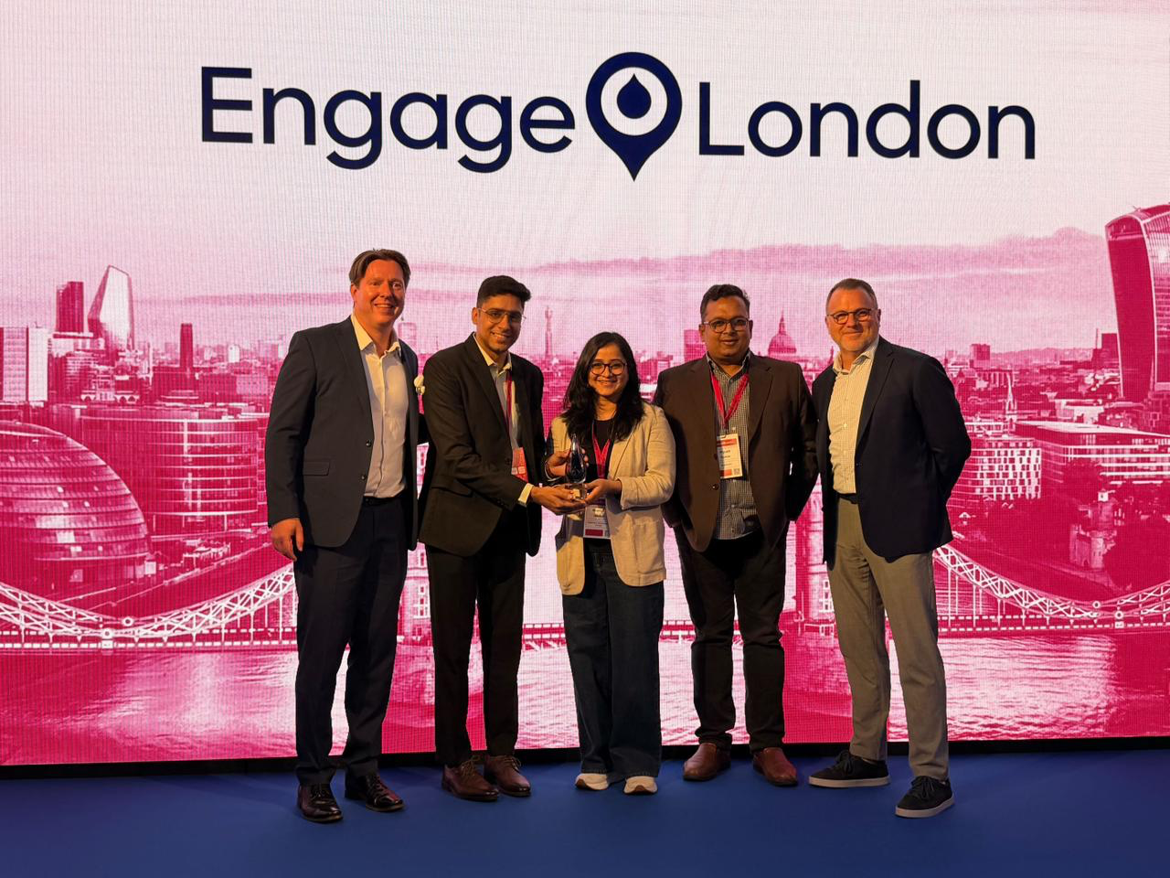 Axelerant team members receiving the Top Technical Excellence Partner of the Year award on stage