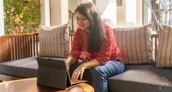 A woman happily sitting for their video interview for a job all carefree.