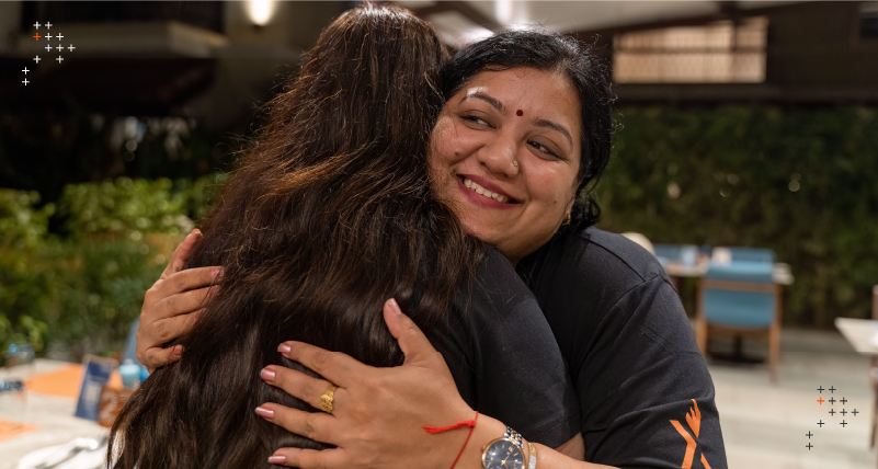 Two team members hugging to show kindness at Axelerant.